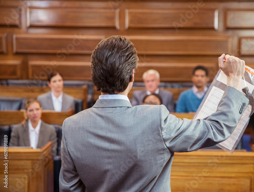 Lawyer showing documents to jury in court 