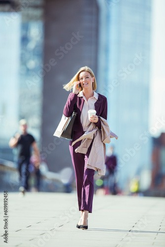 Businesswoman talking on cell phone in city