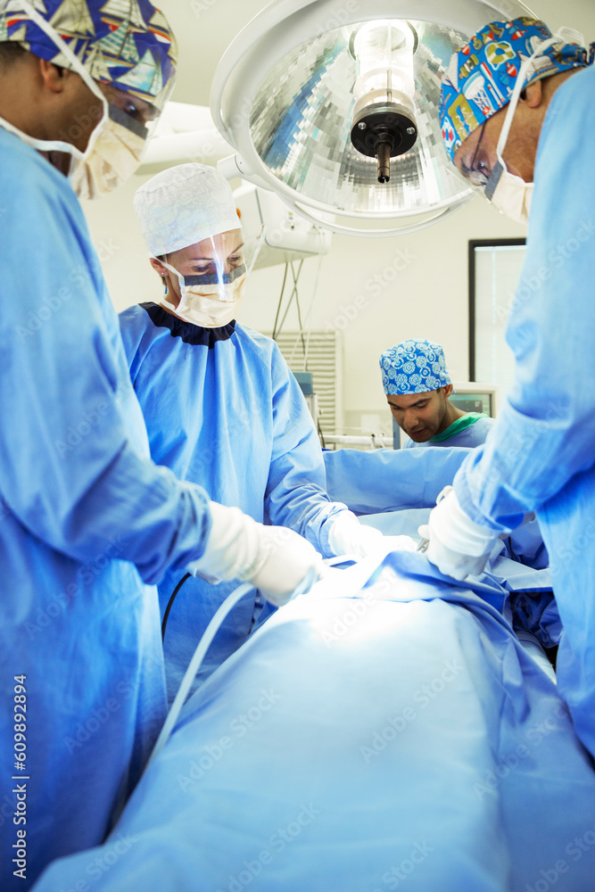 Surgeons performing surgery in operating room Surgeons performing surgery in operating room