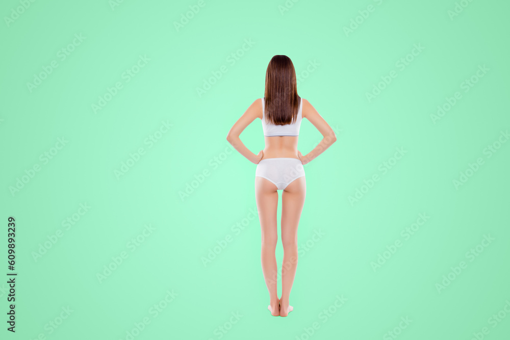 Full length rear view of perfect seductive girl with fit booty bum and slim legs wearing cotton underwear holding two hands on waist demonstrate ideal figure isolated on white background Full length rear view of perfect seductive girl with fit booty bum and slim legs wearing cotton underwear holding two hands on waist demonstrate ideal figure isolated on white background