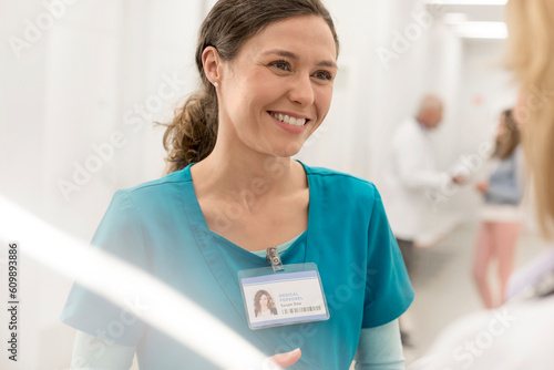 Smiling nurse talking to doctor in hospital corridor photo
