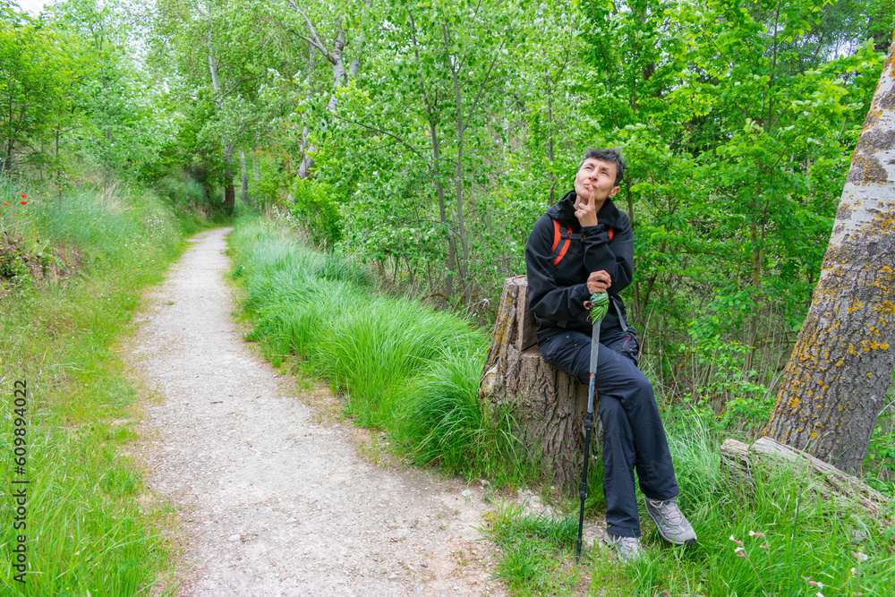 Fototapeta premium woman hiker resting on the trail