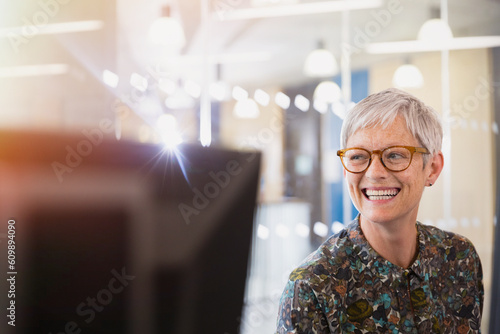 Fotografija Enthusiastic senior businesswoman looking away in office