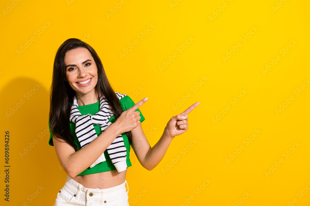 Portrait of young promoter lady directing index fingers copy space black friday offers isolated yellow color background Portrait of young promoter lady directing index fingers copy space black friday offers isolated yellow color background