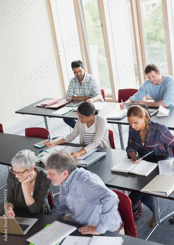 Students studying in adult education classroom