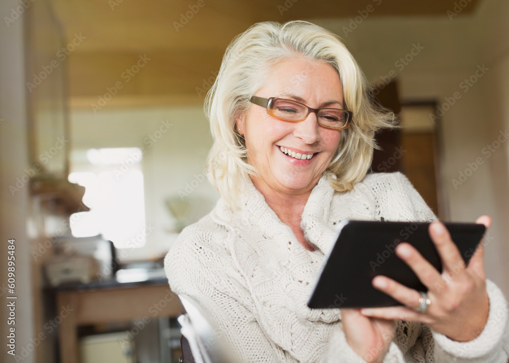 Smiling senior woman using digital tablet Smiling senior woman using digital tablet