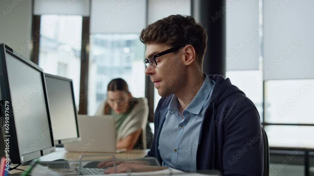 Focused programmer checking code at desk. It guy professional solving problem Focused programmer checking code at desk. It guy professional solving problem