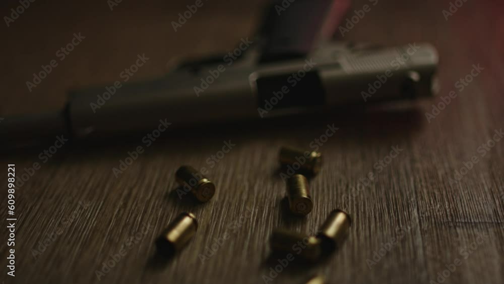 Slow dolly in to empty pistol on a police crime scene with empty bullet casings on the floor Slow dolly in to empty pistol on a police crime scene with empty bullet casings on the floor