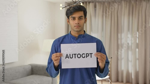 Indian boy holding AUTOGPT banner photo