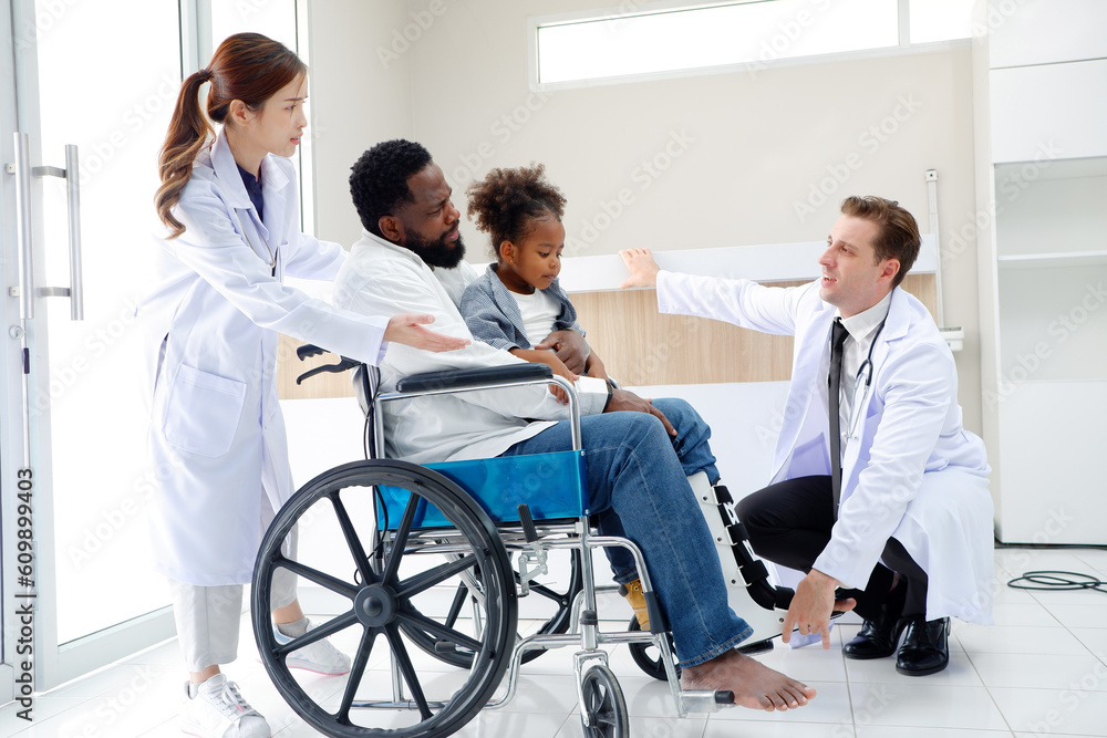 Doctor examining broken leg patient sitting in wheelchair. Doctor examining broken leg patient sitting in wheelchair.