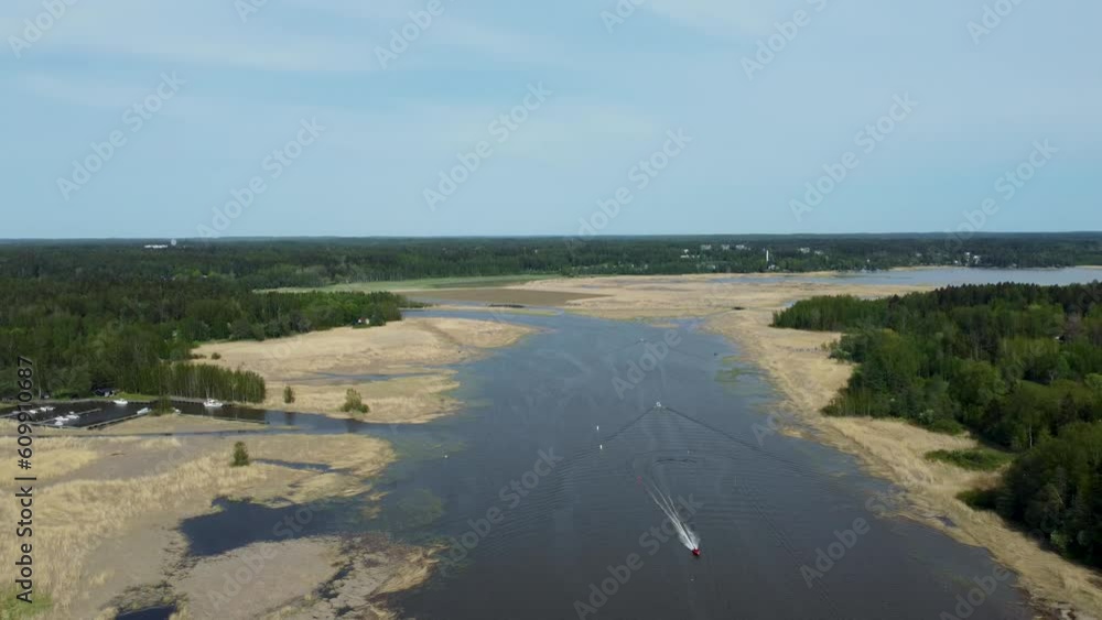 Flowing through the landscape, a wide river is bordered by forests on one side and a charming town on the other, showcasing a harmonious coexistence of nature and human settlement. Flowing through the landscape, a wide river is bordered by forests on one side and a charming town on the other, showcasing a harmonious coexistence of nature and human settlement.