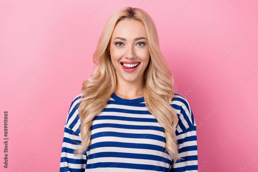Photo of young optimistic woman wear striped pullover tongue teeth tongue girlish wavy blonde flirting isolated on pink color background Photo of young optimistic woman wear striped pullover tongue teeth tongue girlish wavy blonde flirting isolated on pink color background