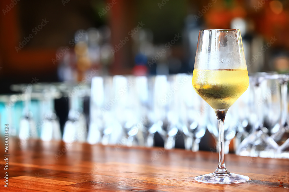 a glass of white wine in a restaurant, alcohol luxury background