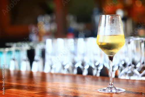 a glass of white wine in a restaurant, alcohol luxury background © kichigin19