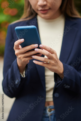 Smartphone in manicured hands of female entrepreneur