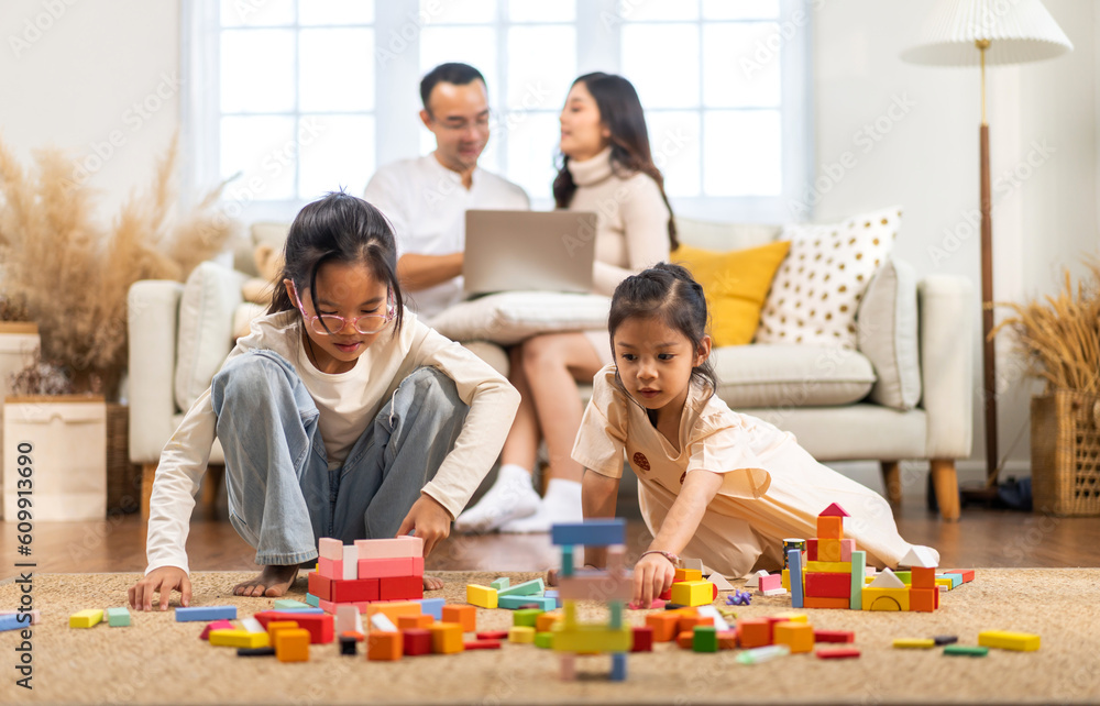 Portrait of enjoy happy love asian family father and mother with little asian girl smiling activity learn and skill brain training play with toy build wooden blocks board education game at home Portrait of enjoy happy love asian family father and mother with little asian girl smiling activity learn and skill brain training play with toy build wooden blocks board education game at home