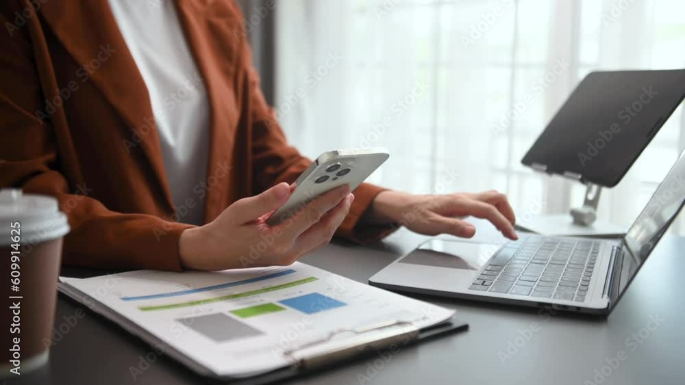 businesswoman hand working with digital tablet computer and smart phone with financial business strategy layer effect on desk in morning light. businesswoman hand working with digital tablet computer and smart phone with financial business strategy layer effect on desk in morning light.