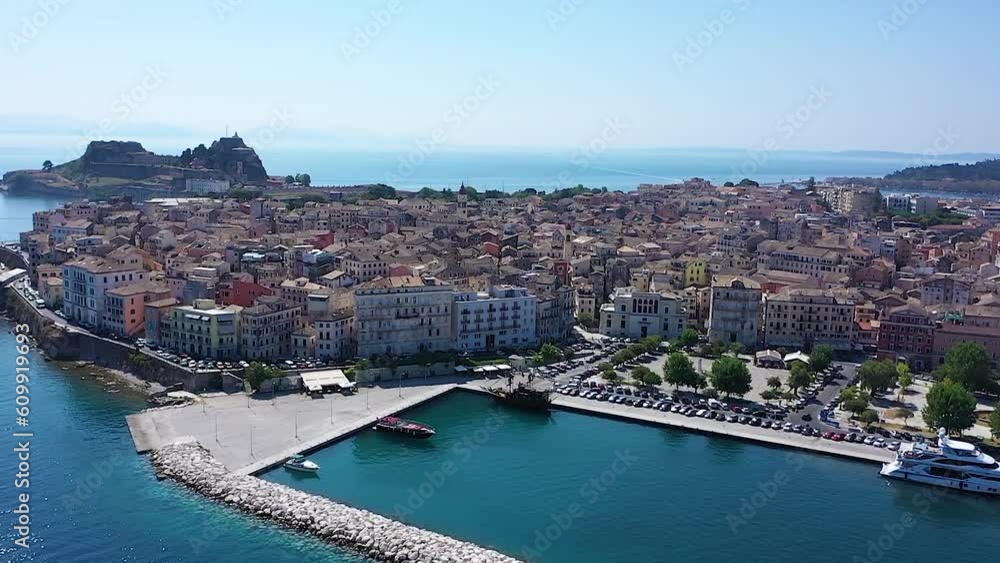 Cinematic shot of town Corfu, Greece. Aerial view of houses in coastal city. Cinematic shot of town Corfu, Greece. Aerial view of houses in coastal city.