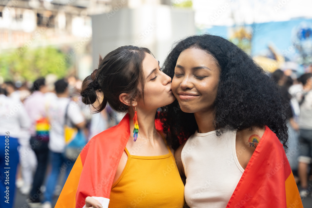 Portrait of Happy loving homosexual lesbian LGBT couple kissing at city streets. LGBT and Pride concept.