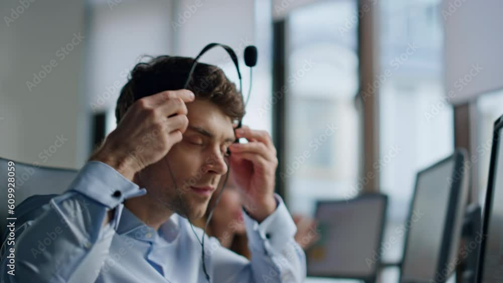 Call operator hand taking headset closeup. Support professional talking customer