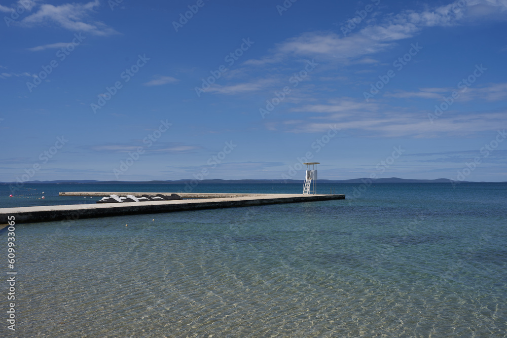  Zaton, Croatia - May 18, 2023 - the sea beach and lifeguard stand in Zaton on the morning of a sunny spring day  