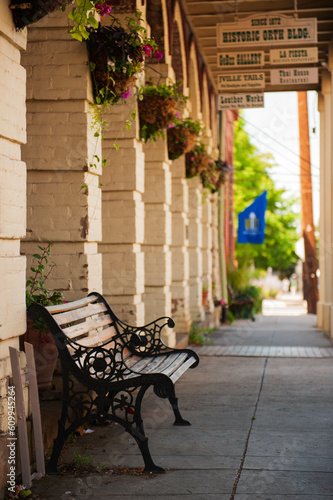 bench into the sidewalk of historic Orth buiding of Jacksonville, Oregon - focus on foreground