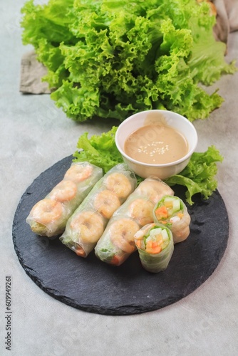 Fresh summer rolls with shrimp and vetgetables,Vietnamese food for healthy food concept with salad dressing
 photo