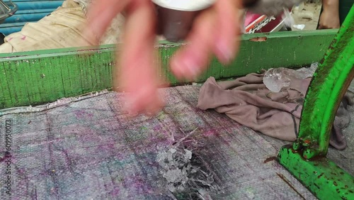 Closeup of male hands making an iced popsicle or ice gola with crushed ice