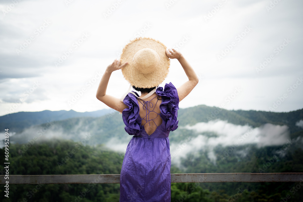 Carefree happy woman in morning of nature cliff mountain. Woman travel tourist alone morning freedom and happiness