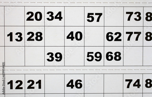 Close up photo of random numbers on paper bingo card photo