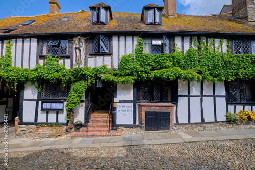 Rye, East Sussex, England, Europe - May 18, 2023: The Mermaid - ancient hotel on a cobblestoned street. A small English medieval coastal town on a sunny day.