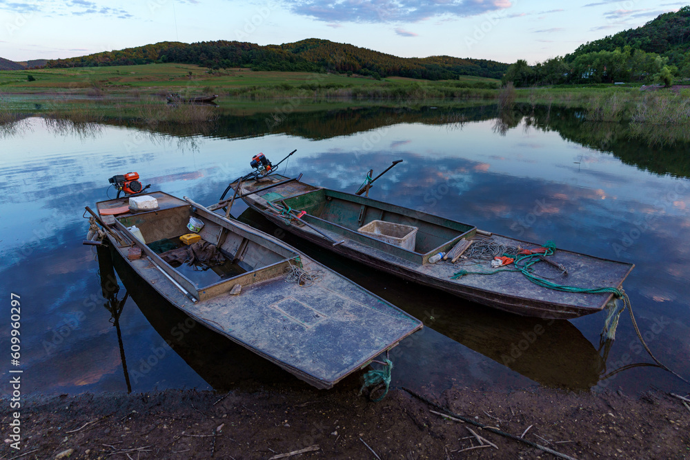 Small iron boat docked by the water Small iron boat docked by the water
