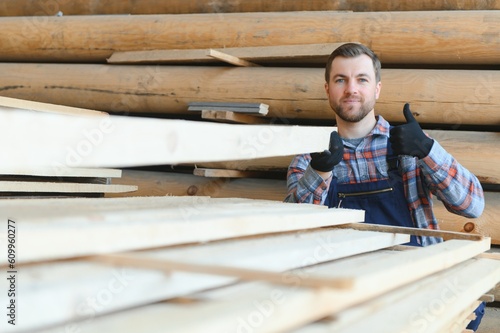 Male Worker folds boards. Sawmill. Wood harvesting process