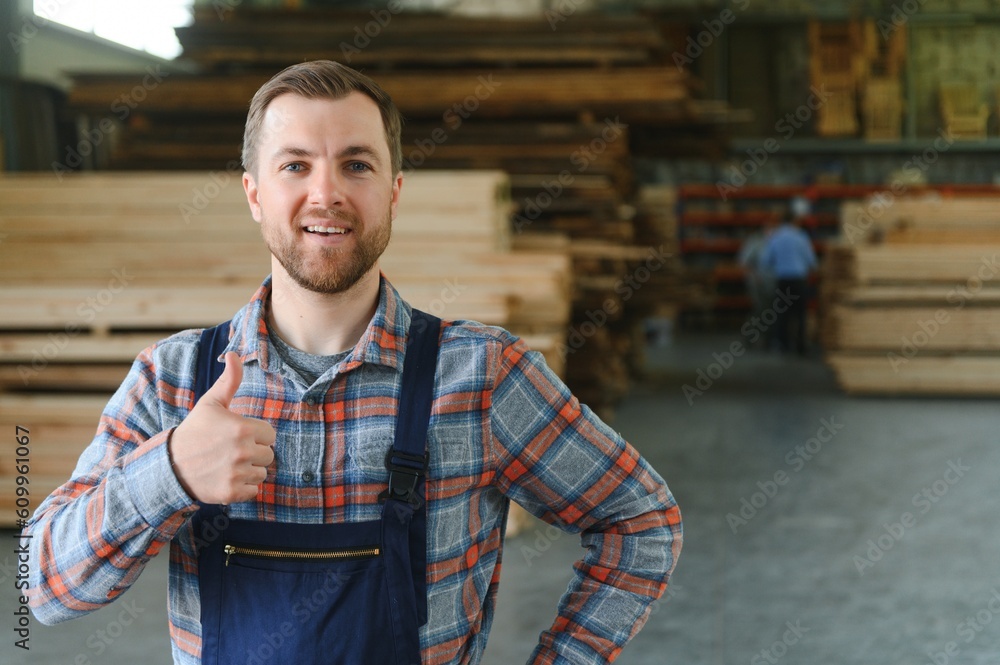 Carpenter in the wood warehouse selects plank for furniture making in the carpentry workshop Carpenter in the wood warehouse selects plank for furniture making in the carpentry workshop