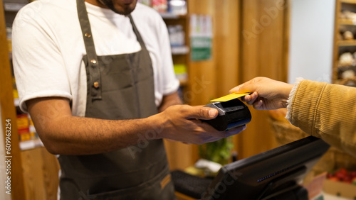 Crop customer paying with credit card in shop photo