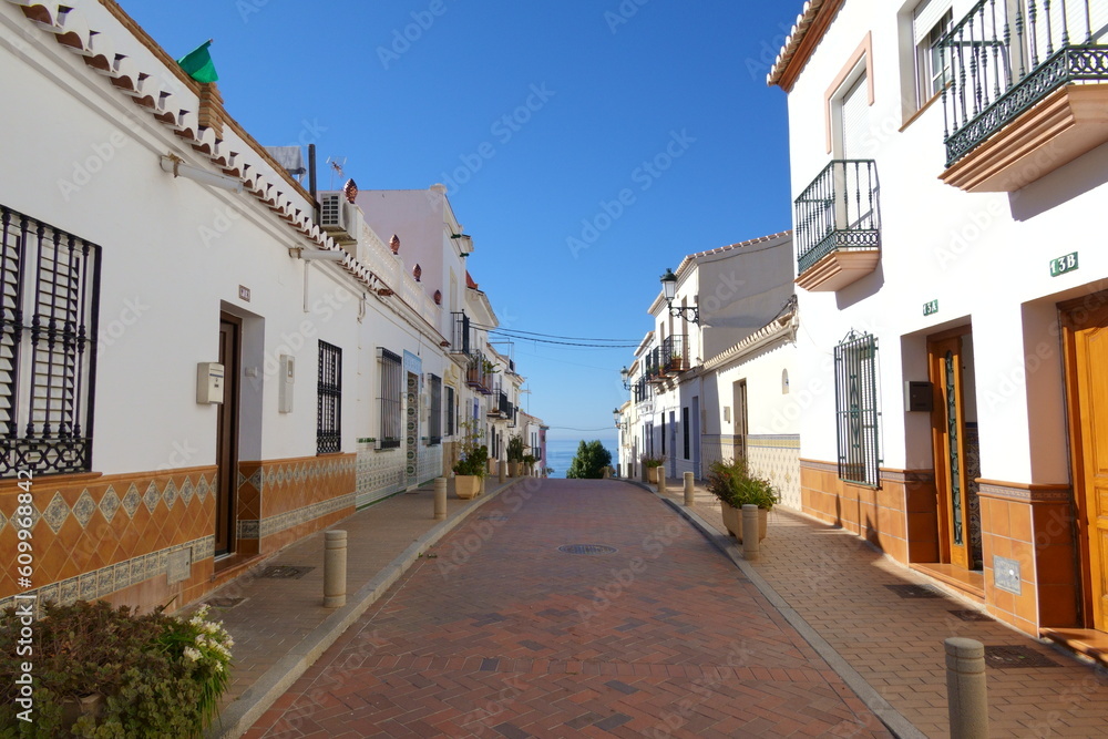 Street with white houses  in a traditional Andalusian village in southern Spain
