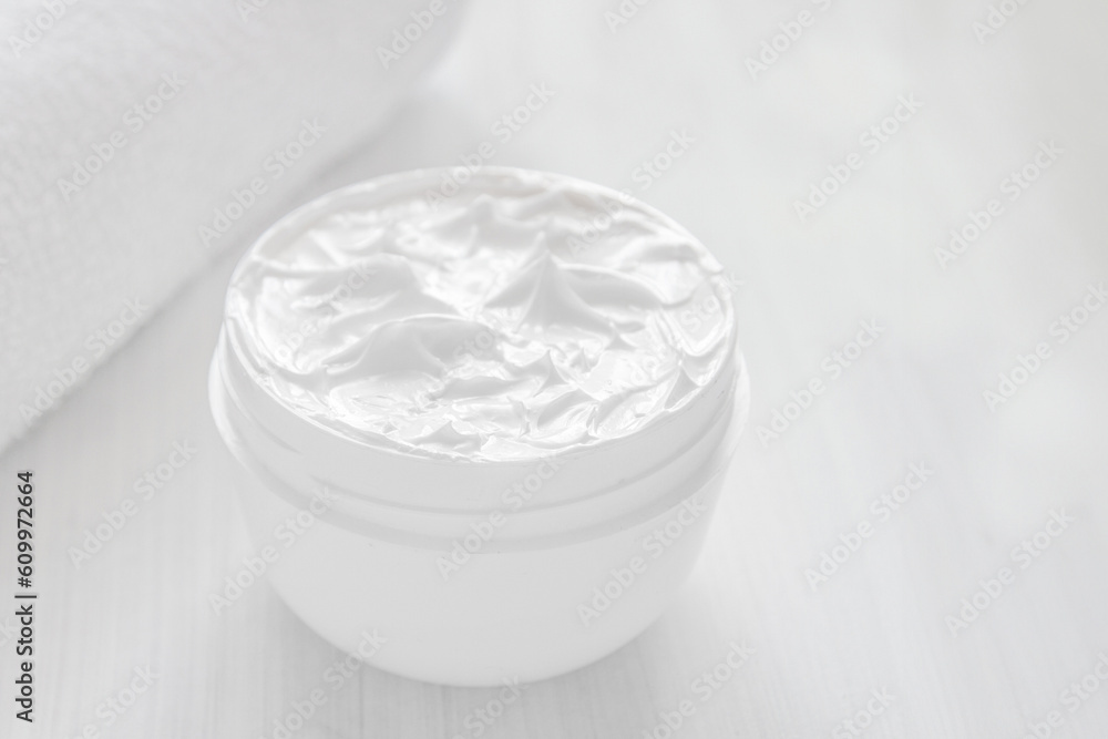 Pure white moisturizer in a white jar. Pure white moisturizer in a white jar.