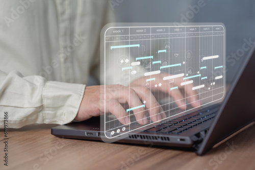 Business man working data analytics with computer in business management system to make report with KPI and metrics connected to database. Corporate strategy for finance, marketing, operations, sales.