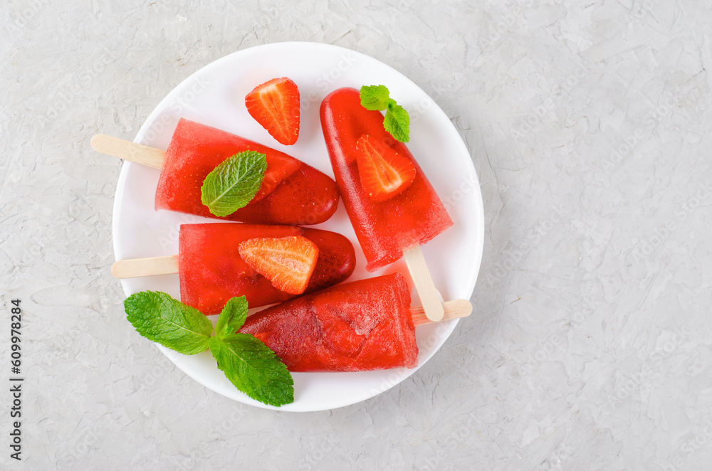 Refreshing Strawberry Popsicles, Ice Lolly with Fresh Strawberry and Mint on Bright Background Refreshing Strawberry Popsicles, Ice Lolly with Fresh Strawberry and Mint on Bright Background