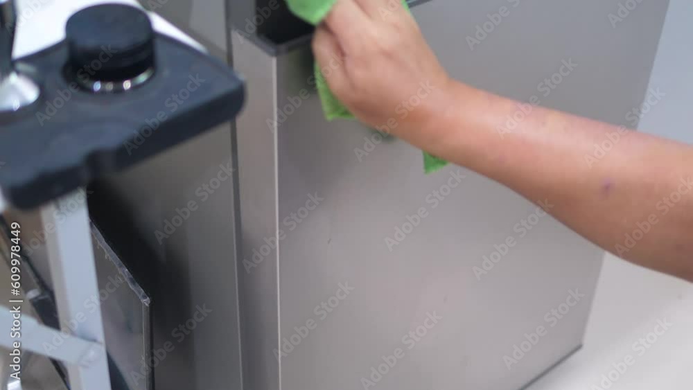 People use the green microfiber fabric to cleaning up a refrigerator People use the green microfiber fabric to cleaning up a refrigerator