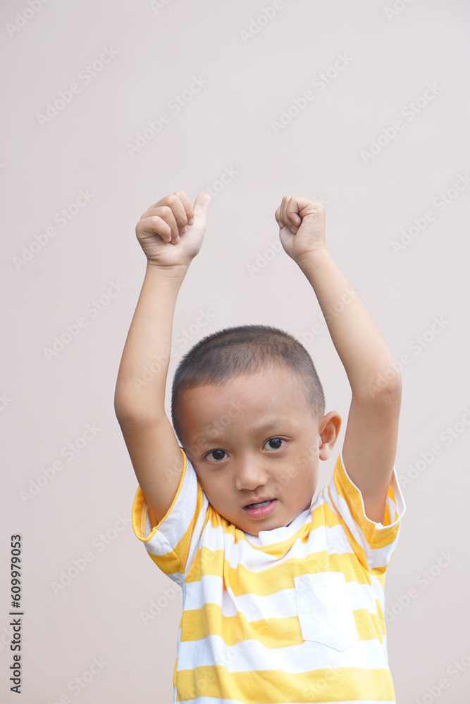 Asian boy smiling happily, cream background Asian boy smiling happily, cream background