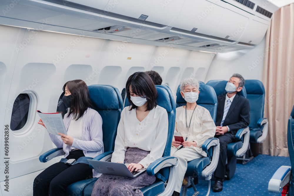 マスクをして飛行機に乗る乗客 マスクをして飛行機に乗る乗客
