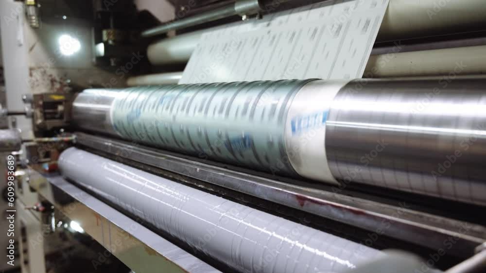 Printing machine applies pattern on paper sheet in workshop Printing machine applies pattern on paper sheet in workshop