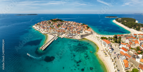 Fototapeta Naklejka Na Ścianę i Meble -  Aerial panoramic view with scenic town and beaches of Primosten in Croatia, famous and picturesque tourist resort at Adriatic sea coast.