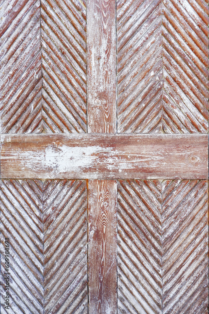 Natural textured background of old wooden boards with worn light paint.The boards are laid with a herringbone or a corner. An element of an old door. Vertical photography Natural textured background of old wooden boards with worn light paint.The boards are laid with a herringbone or a corner. An element of an old door. Vertical photography