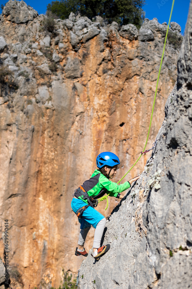 climber boy. the child trains in rock climbing. climber boy. the child trains in rock climbing.