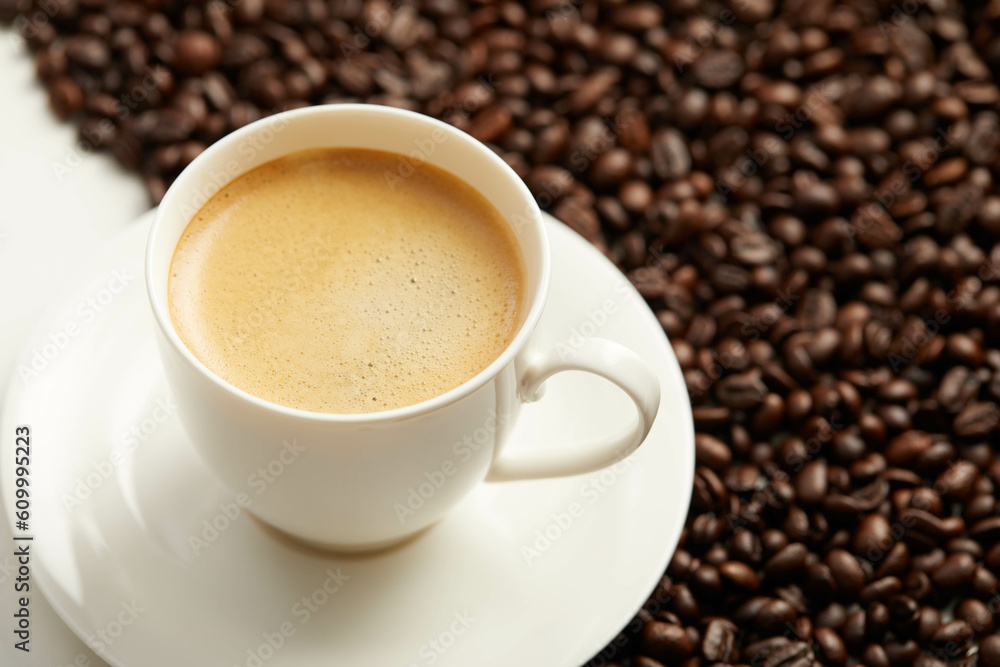 Cup of coffee and coffee beans and spoon, Isolated on a white background Cup of coffee and coffee beans and spoon, Isolated on a white background