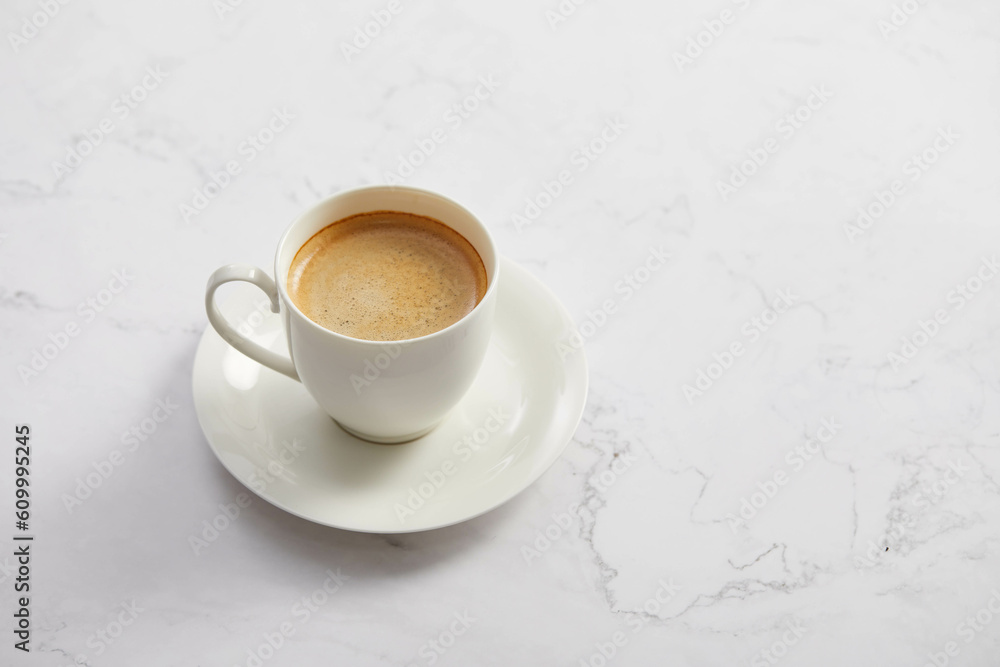 Cup of coffee, on white marble table Cup of coffee, on white marble table