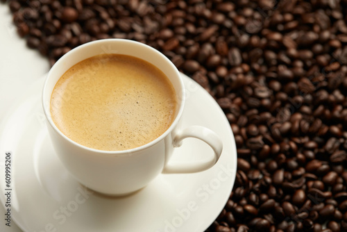 Cup of coffee and coffee beans and spoon, Isolated on a white background