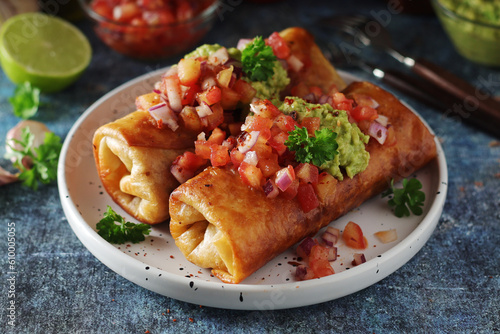 A typical dish of Mexican cuisine - Chimichanga, made of tortilla with different ingredients photo